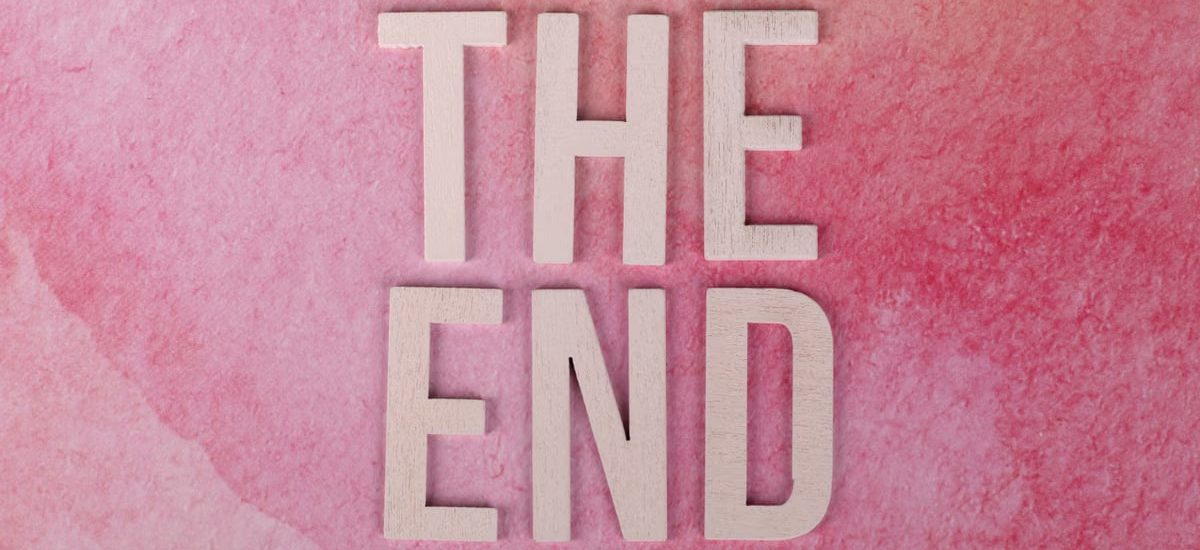 Elegant 'The End' text on a textured pink background, perfect for closure or transition concepts.